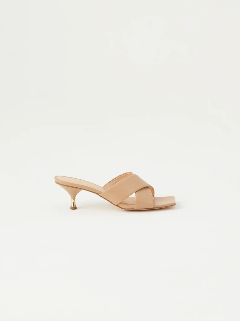 Beige flip-flops with decorative gold element on the heel