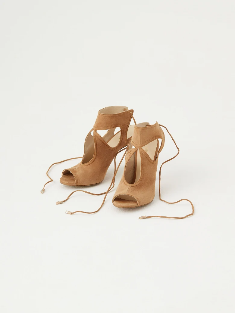 Beige sandals with decorative cutouts and binding