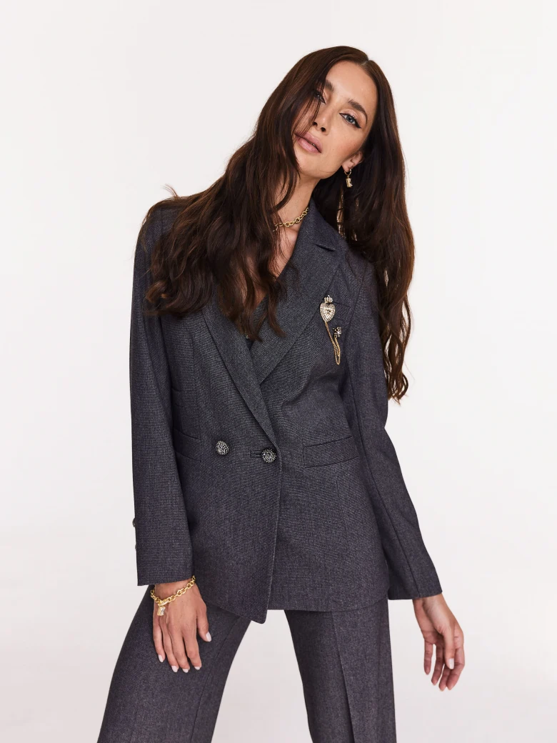Gray jacket with jewelry brooch