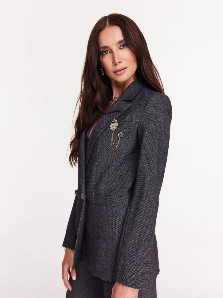 Gray jacket with jewelry brooch