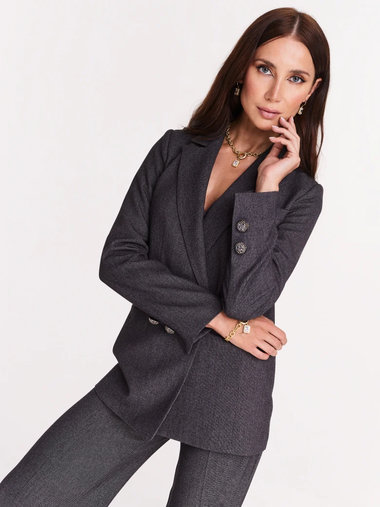Gray jacket with jewelry brooch