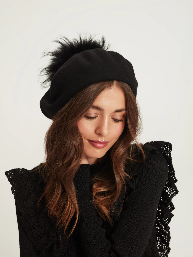 Black beret with decorative pom-pom