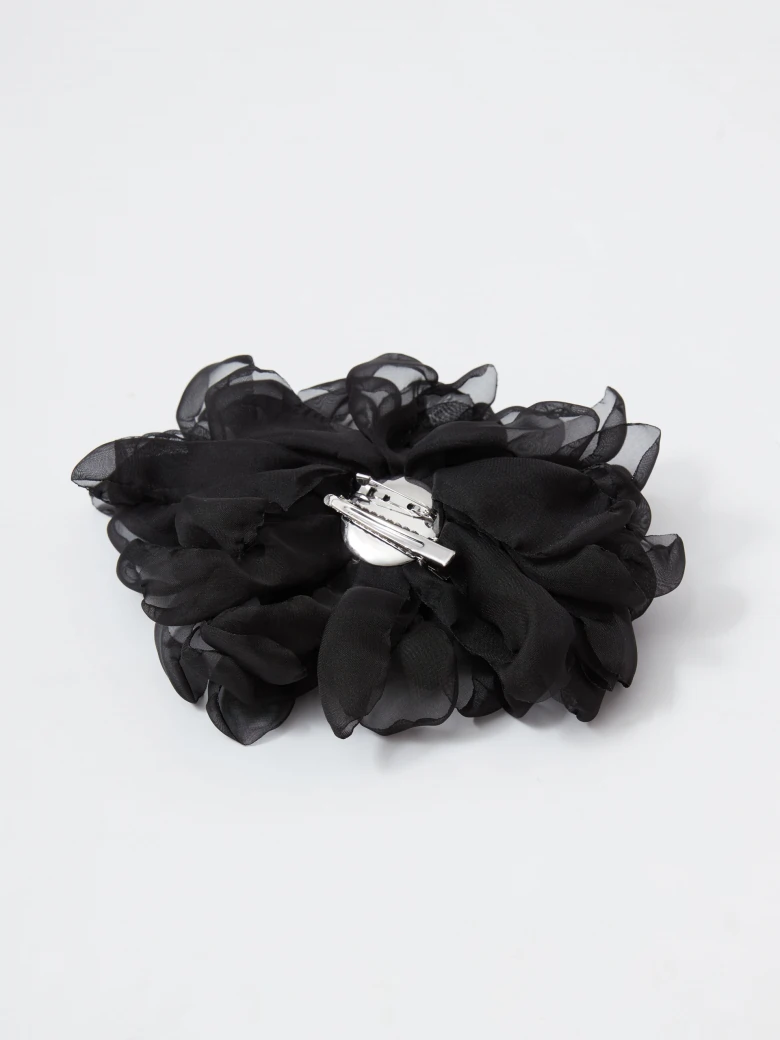 Large black flower-shaped brooch