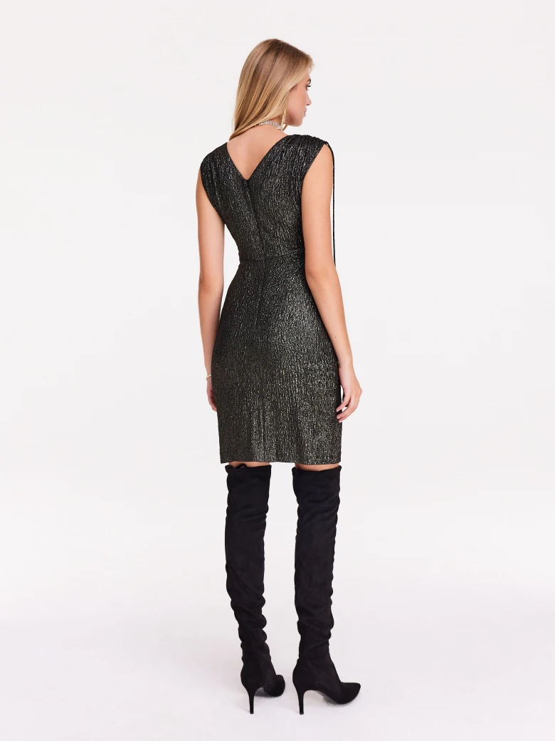 Fitted black and gold dress with shimmering trim