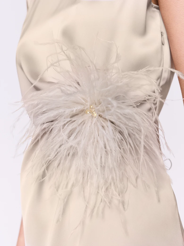 A cream-colored brooch made of bird feathers
