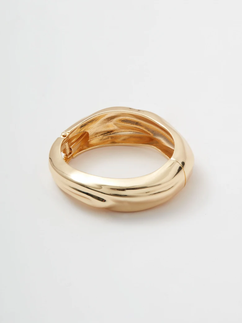 Large gold-plated bracelet with an irregular shape