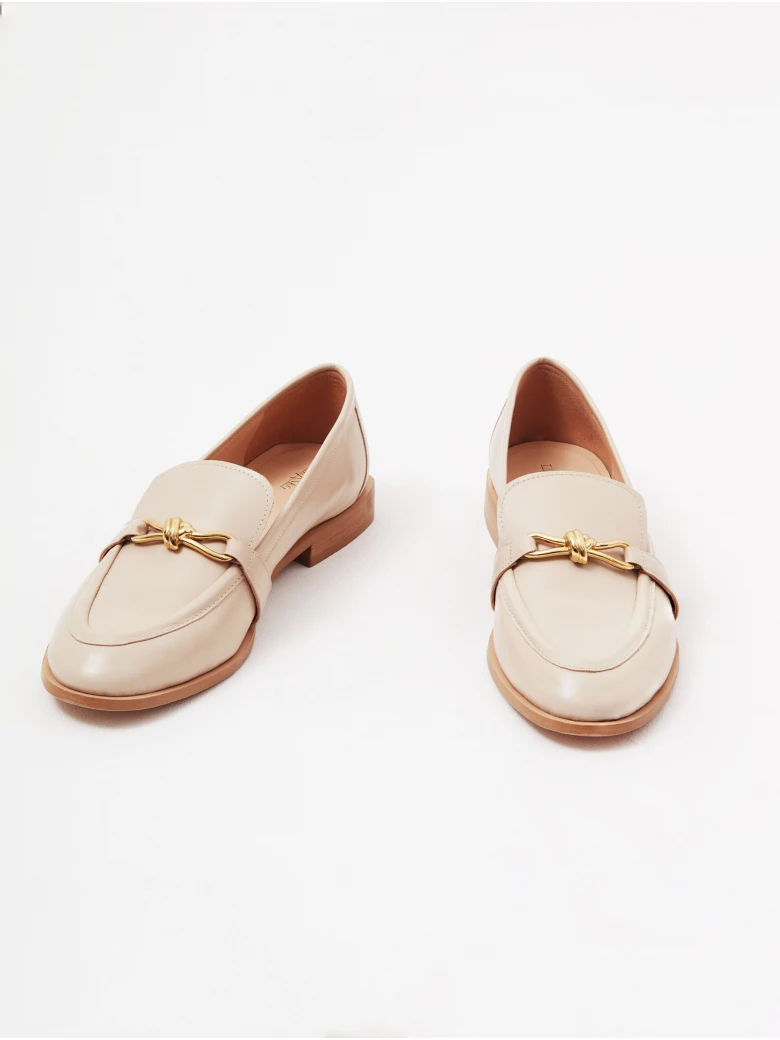 Beige leather moccasins with buckles