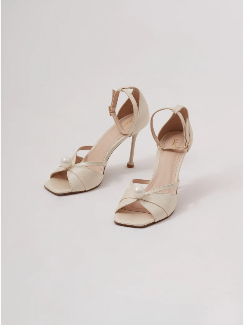 Cream-colored heeled sandals with pearl detailing