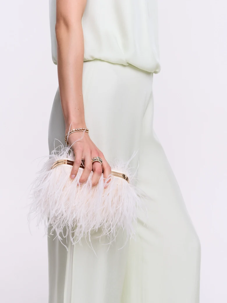 A small cream-colored handbag embroidered with feathers