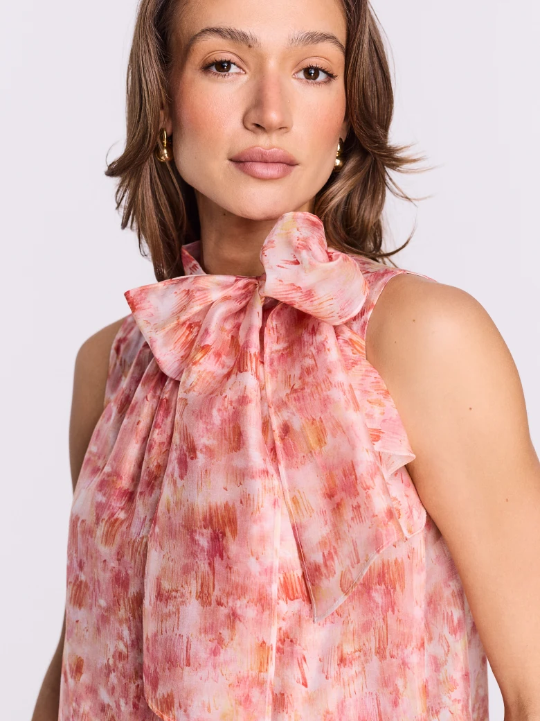Pink blouse with a colorful patterned sash