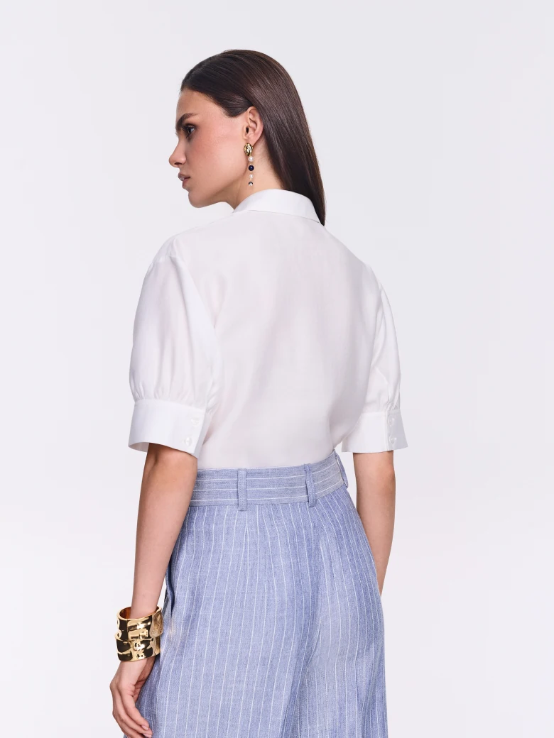 An elegant white short-sleeved shirt