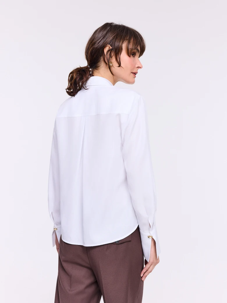 Elegant white shirt with gold-colored buttons