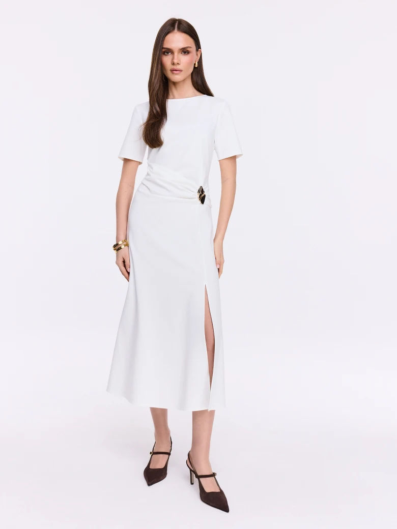 White dress with ruffles and decorative buckle