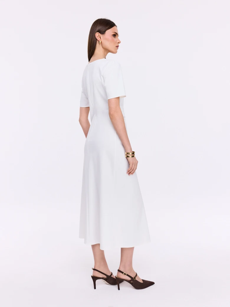 White dress with ruffles and decorative buckle
