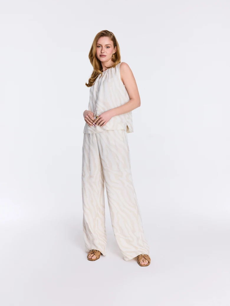 Light-colored pants with an animal print and linen accents