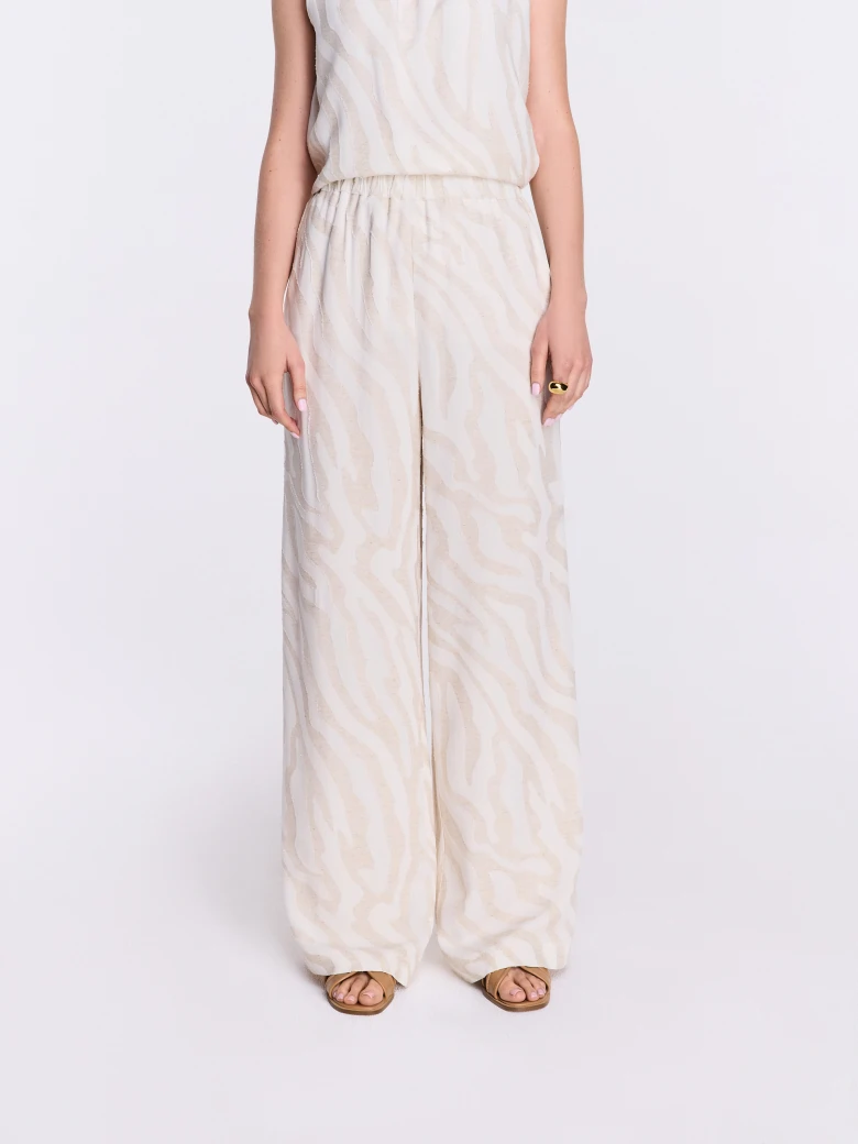 Light-colored pants with an animal print and linen accents