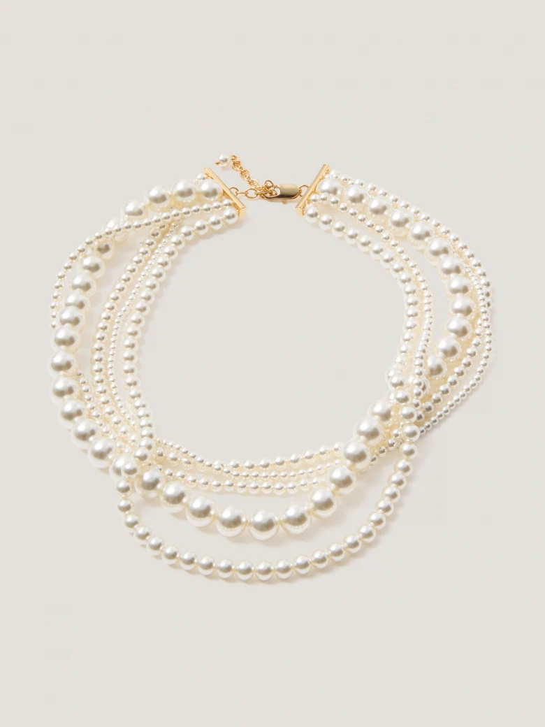 A multi-strand necklace made of pearl beads
