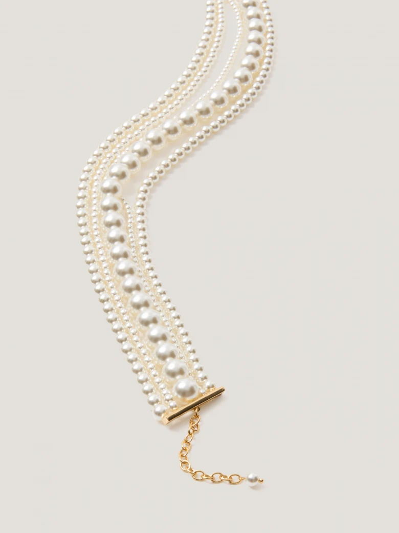 A multi-strand necklace made of pearl beads